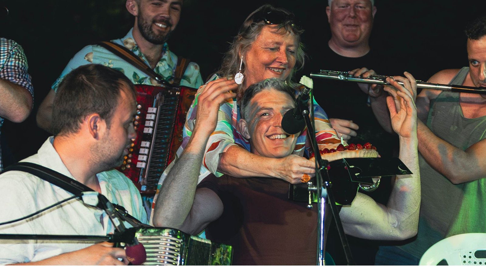 Irish traditional musicians celebrating on stage during a live performance at the Athens Irish Festival in Athens, Greece